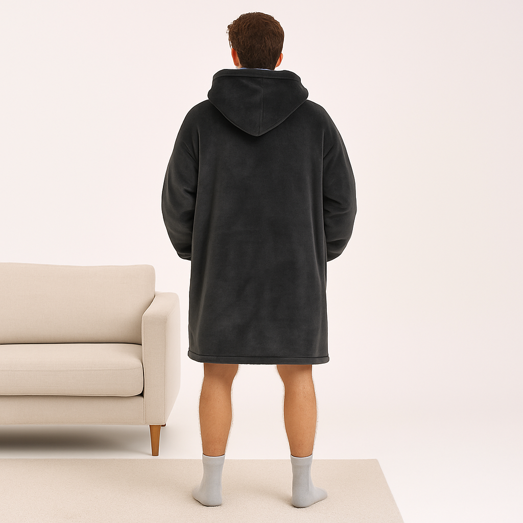 Back view of dark grey fleece hoodie blanket on male model