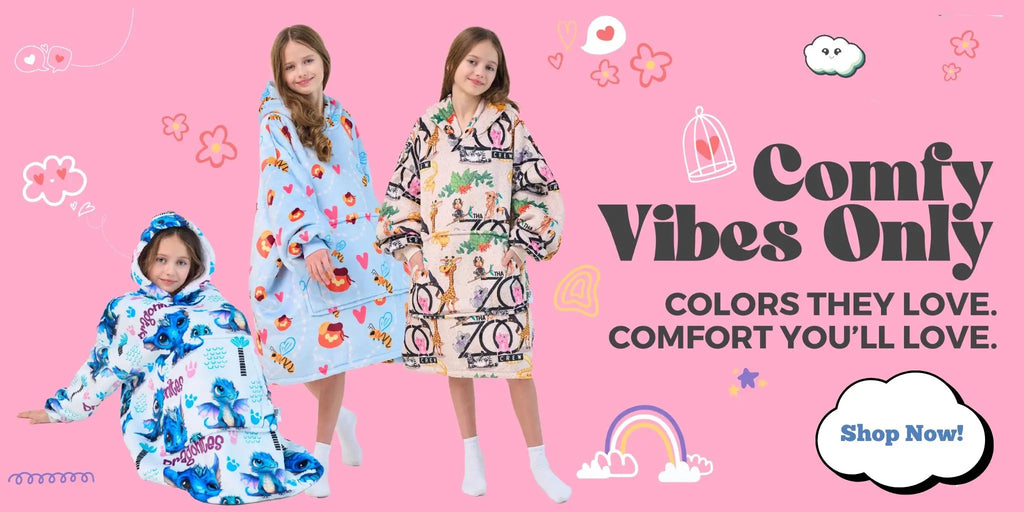 Three girls wearing colorful wearable blankets from Hoodie Haven, featuring dragon, heart, and jungle prints, on a pink background with the headline “Comfy Vibes Only”.
