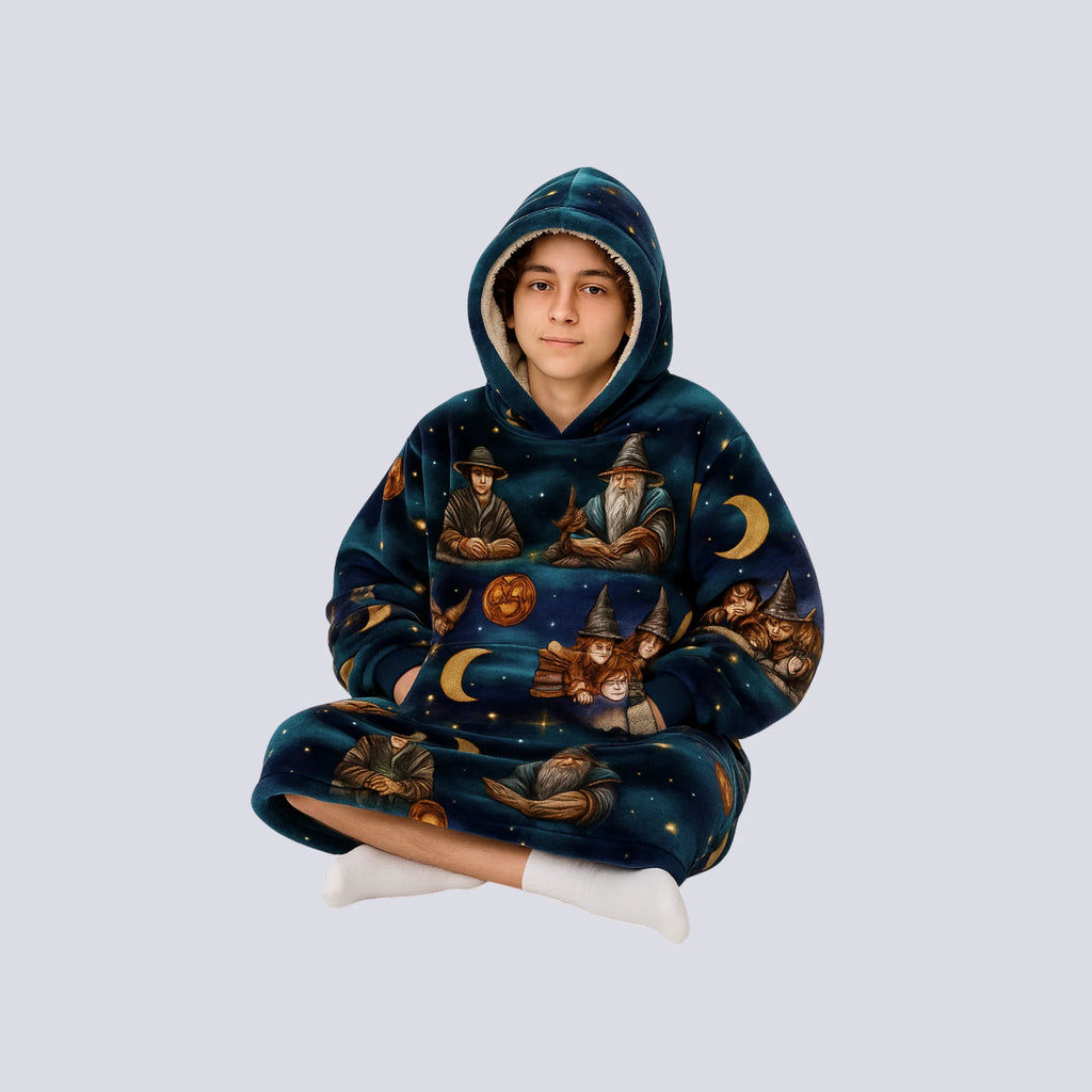Teen wearing the Wise Wizard Warrior hoodie blanket while sitting cross-legged, showcasing cozy oversized fit and comfort.